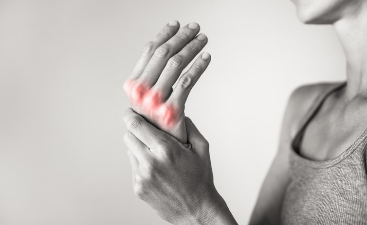 Woman suffering from pain in hands and fingers, arthritis inflammation.